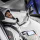 "NASA astronaut Suni Williams, fully suited in SpaceX’s spacesuit, interfaces with the display inside a mock-up of the Crew Dragon spacecraft."